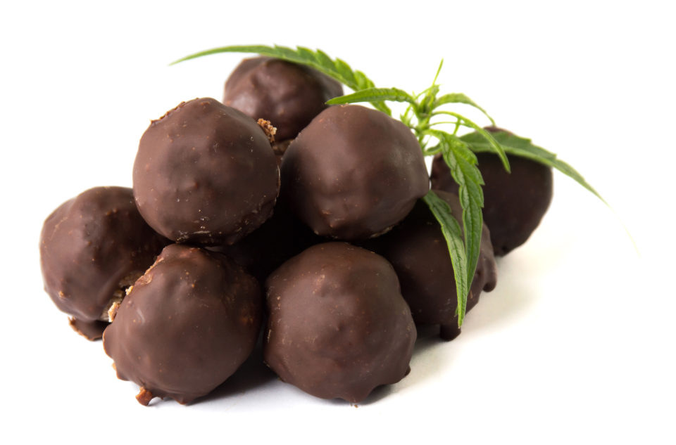 Bunch of homemade chocolate truffles with marijuana leaves